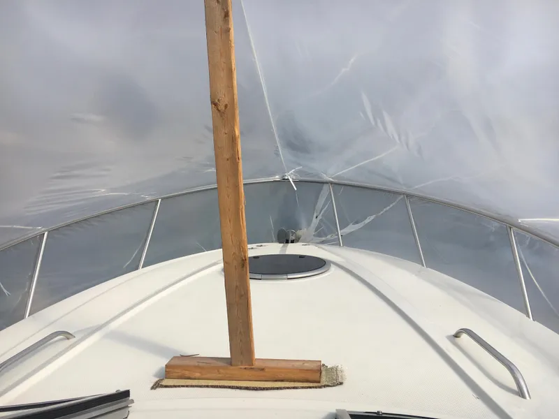 Slide: The Image of 2018 Crownline 264 CR boat under protective cover, view from bow. - 5