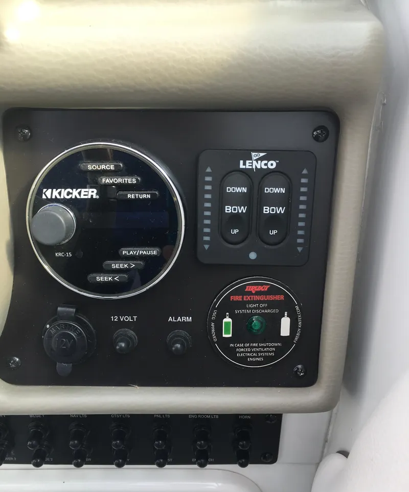 Slide: The Image of Control panel of a 2018 Crownline 264 CR boat with audio and trim controls. - 9