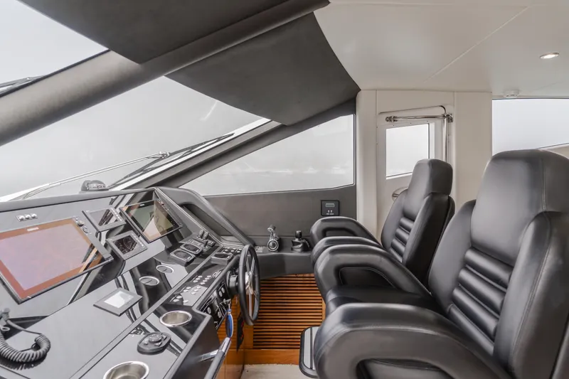 Slide: The Image of Interior helm of 2017 Sunseeker 75 Yacht with modern controls and leather seating. - 25