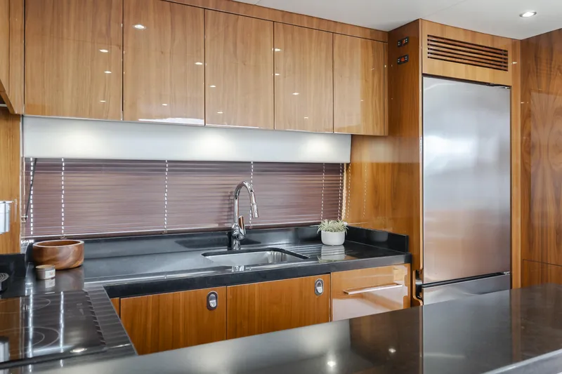 Slide: The Image of Modern kitchen interior on 2017 Sunseeker 75 Yacht with sleek wood cabinetry and stainless steel appliances. - 34