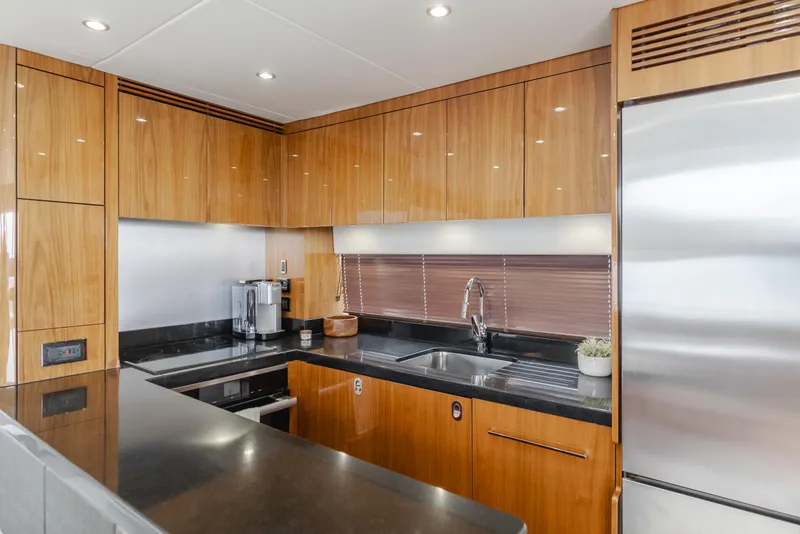 Slide: The Image of Luxurious kitchen interior of 2017 Sunseeker 75 Yacht with modern appliances and wood cabinetry. - 35