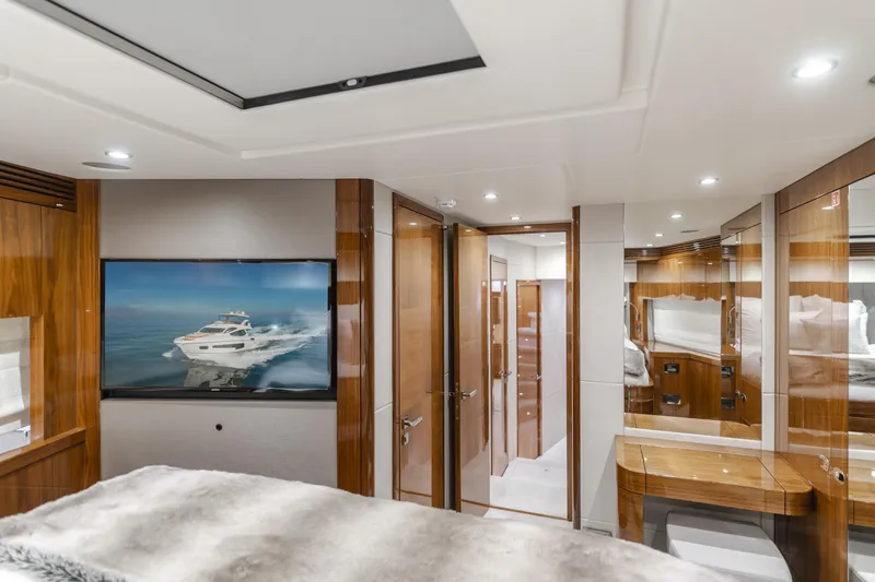 Slide: The Image of Luxurious interior of a 2017 Sunseeker 75 Yacht, featuring elegant wood finishes and modern design. - 42
