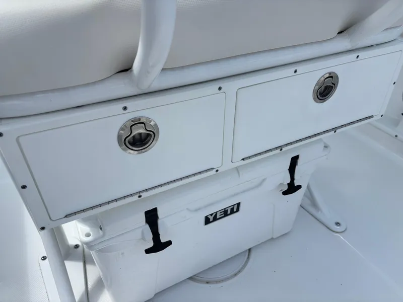 Slide: The Image of 2022 Sea Hunt Ultra 219 boat storage with Yeti cooler underneath. - 11