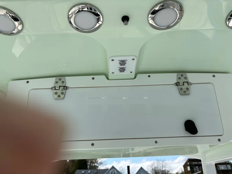 Slide: The Image of 2022 Sea Hunt Ultra 219 boat console with storage compartment and LED lights. - 14