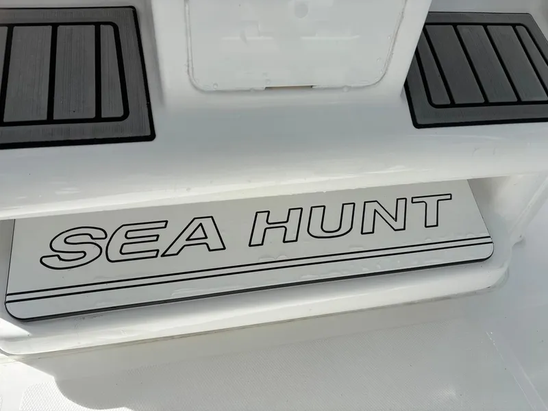 Slide: The Image of 2022 Sea Hunt Ultra 219 boat deck with logo, featuring sleek design elements. - 15
