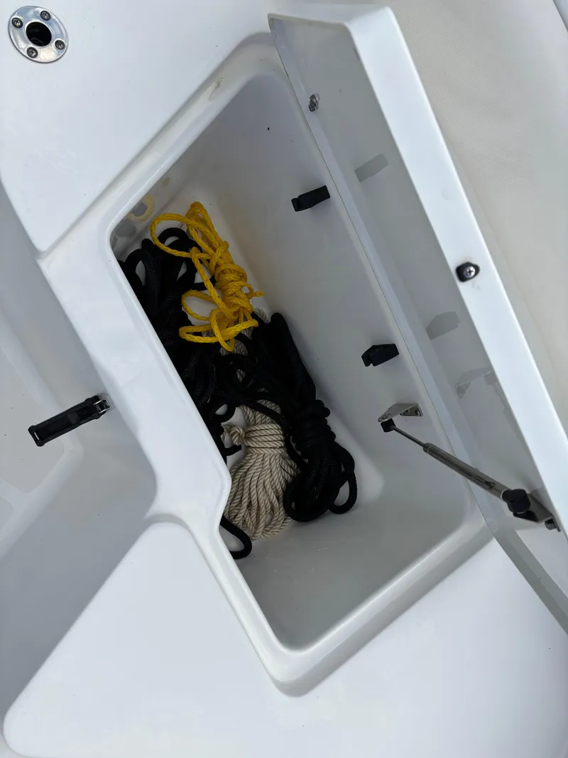 Slide: The Image of Storage compartment on 2022 Sea Hunt Ultra 219 boat with ropes inside. - 19