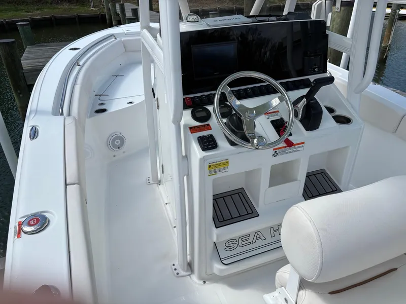 Slide: The Image of 2022 Sea Hunt Ultra 219 boat interior with steering wheel and control panel. - 2