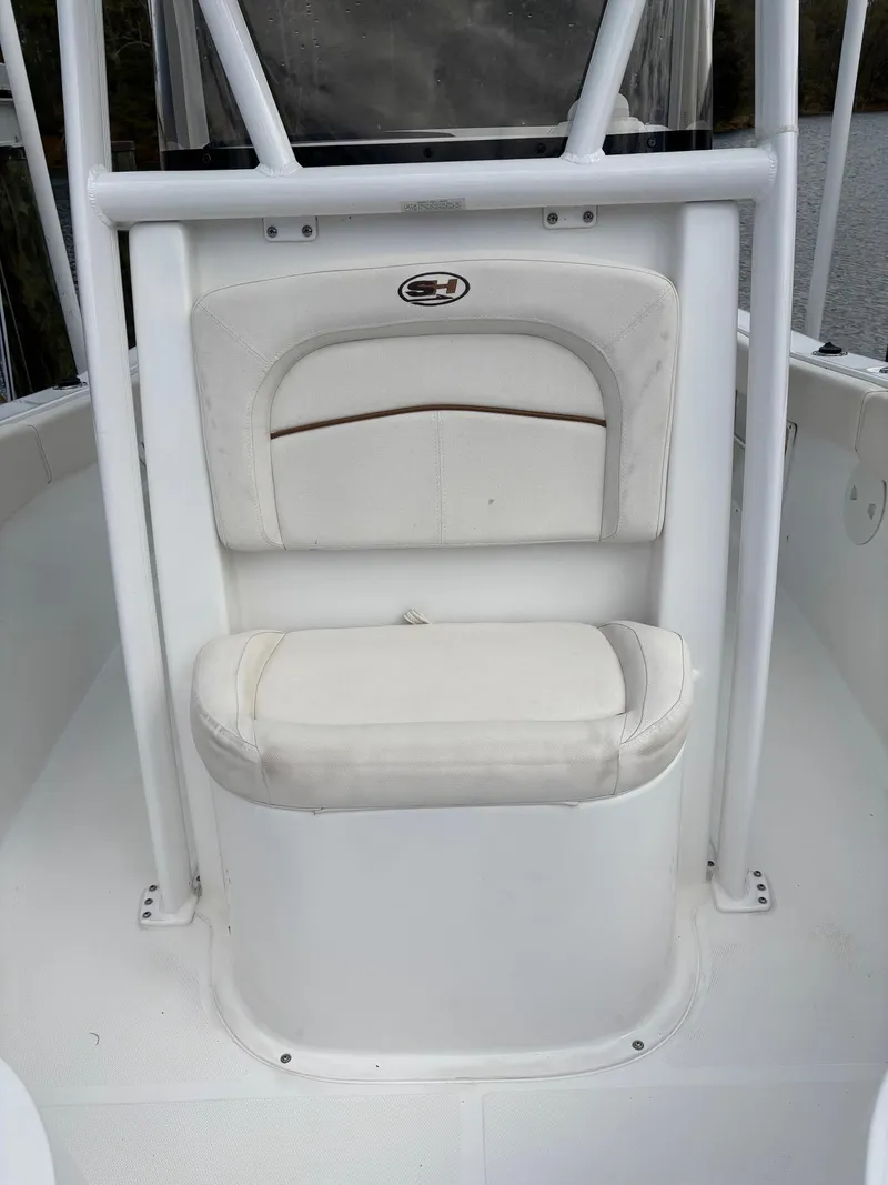 Slide: The Image of 2022 Sea Hunt Ultra 219 boat seating area with white cushioned seat and backrest. - 21
