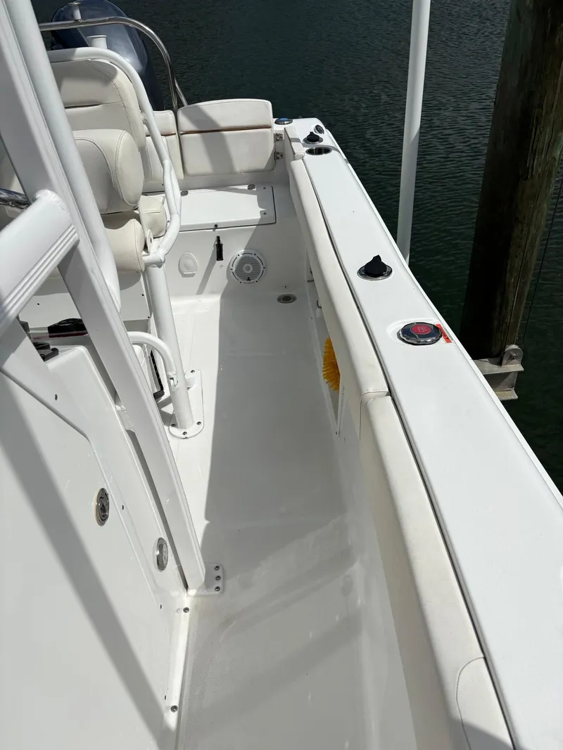 Slide: The Image of 2022 Sea Hunt Ultra 219 boat deck, featuring seating and control panel. - 22