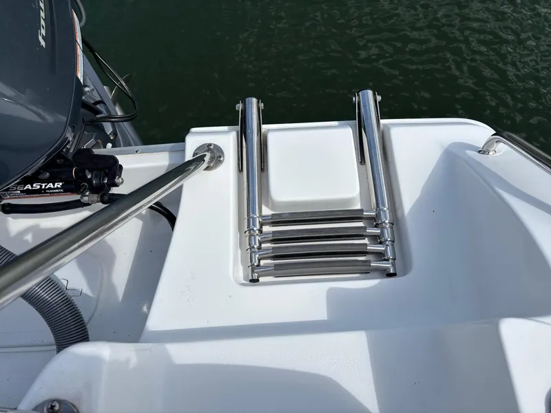 Slide: The Image of Stainless steel ladder on 2022 Sea Hunt Ultra 219 boat, near water. - 24