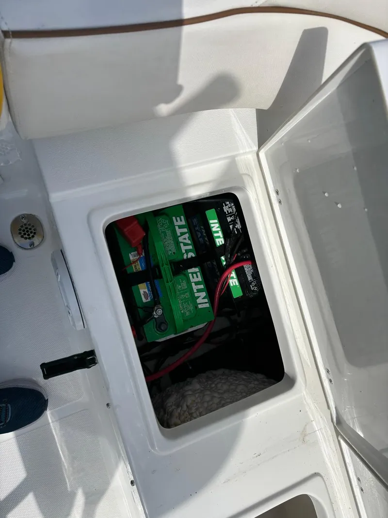 Slide: The Image of Battery compartment of 2022 Sea Hunt Ultra 219 boat, featuring Interstate batteries. - 28