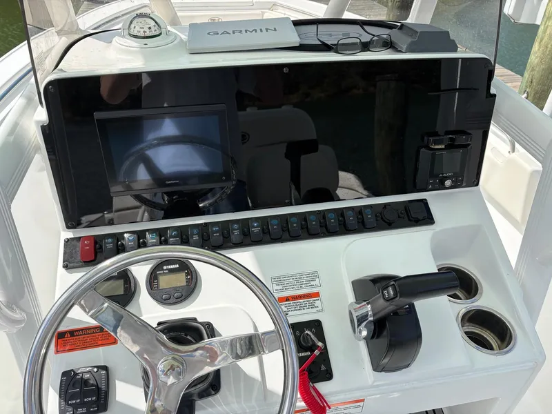 Slide: The Image of 2022 Sea Hunt Ultra 219 dashboard with Garmin navigation and steering controls. - 4