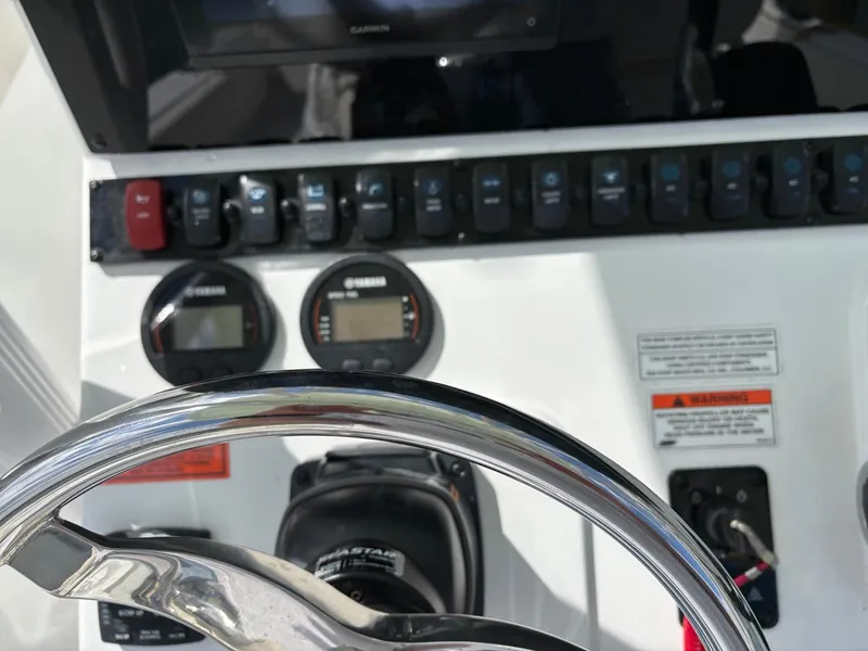 Slide: The Image of Control panel of 2022 Sea Hunt Ultra 219 boat with steering wheel and gauges. - 5