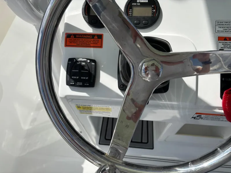 Slide: The Image of Steering wheel and controls of 2022 Sea Hunt Ultra 219 boat. - 6