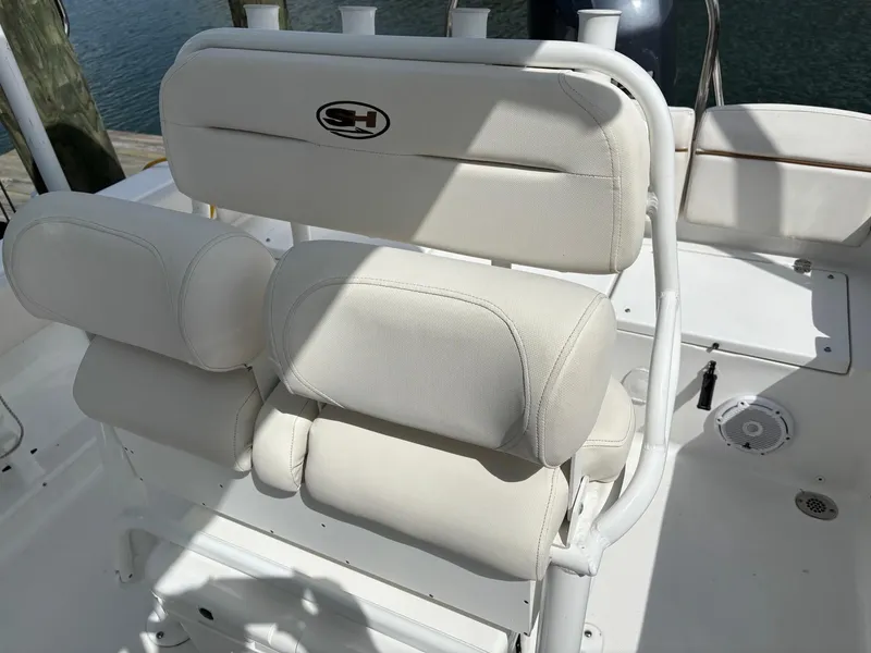 Slide: The Image of 2022 Sea Hunt Ultra 219 boat seating with white cushioned seats and SH logo. - 8