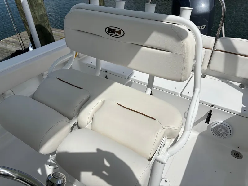 Slide: The Image of 2022 Sea Hunt Ultra 219 boat seating with white cushioned seats and backrest. - 9