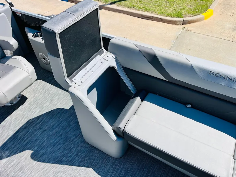 Slide: The Image of 2021 Bennington SX 22 Stern Lounge interior with open storage compartment, gray seating, and carpeted floor. - 14