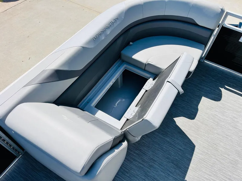 Slide: The Image of 2021 Bennington SX 22 Stern Lounge with open storage compartment, featuring sleek gray seating. - 15