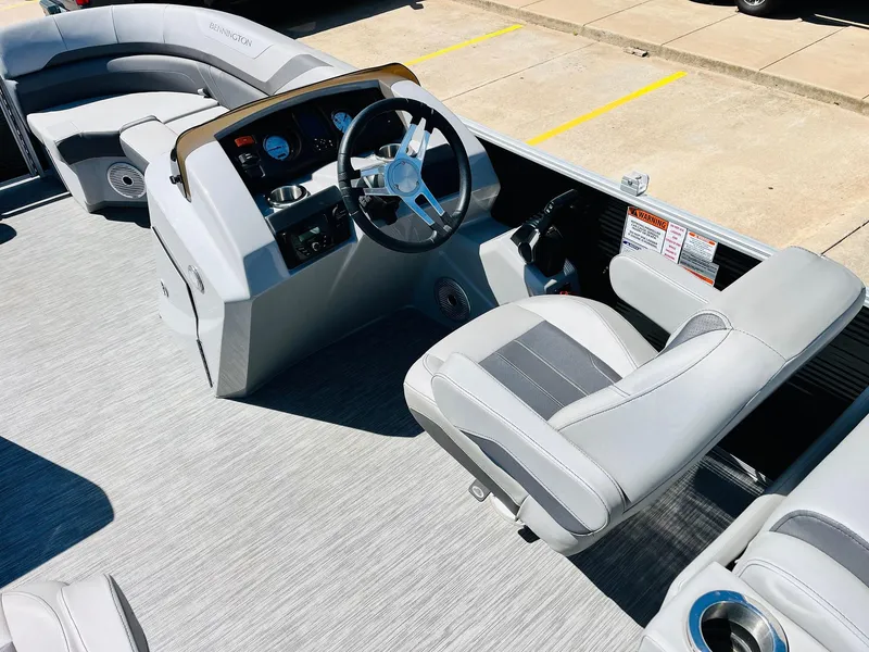Slide: The Image of 2021 Bennington SX 22 Stern Lounge boat interior with steering wheel and seating. - 25