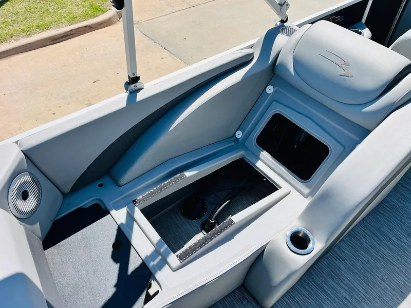 Slide: The Image of 2021 Bennington SX 22 Stern Lounge interior with storage compartments and cup holder. - 30