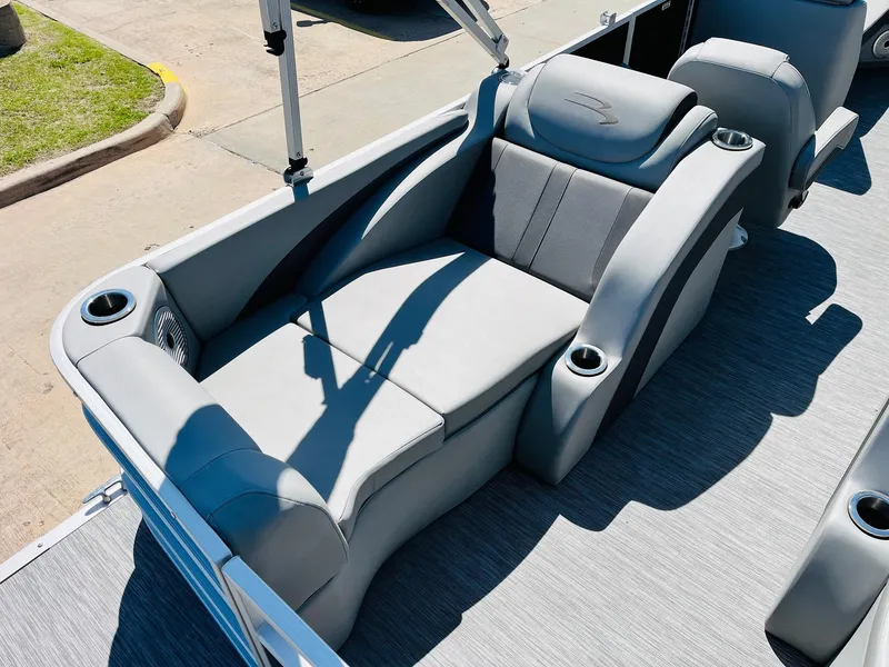 Slide: The Image of 2021 Bennington SX 22 Stern Lounge with gray seating and cup holders on a sunny day. - 31