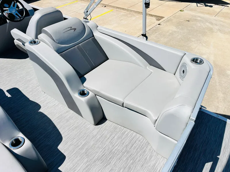 Slide: The Image of 2021 Bennington SX 22 Stern Lounge with gray seating and cup holders on a boat deck. - 32