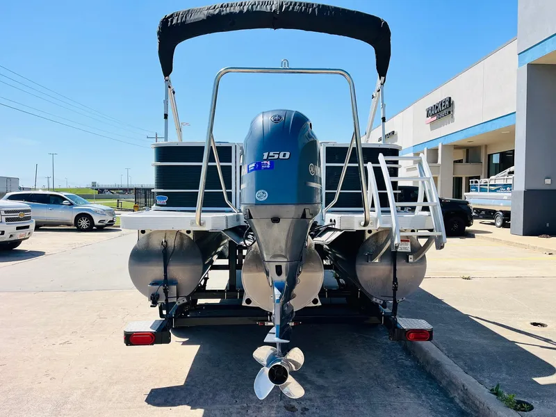 Slide: The Image of 2021 Bennington SX 22 Stern Lounge pontoon boat with outboard motor, parked outdoors. - 7