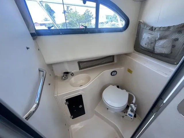 Slide: The Image of 2007 Grady-White 282 Sailfish boat interior with compact bathroom and window. - 14