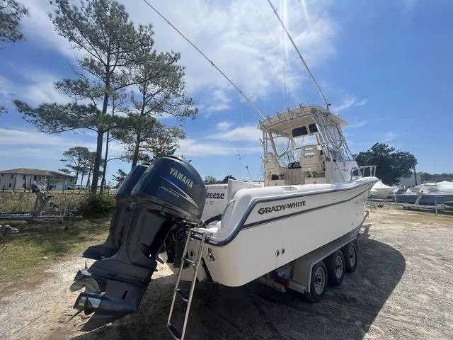 Slide: The Image of 2007 Grady-White 282 Sailfish boat with Yamaha outboard, parked on a trailer under clear skies. - 6
