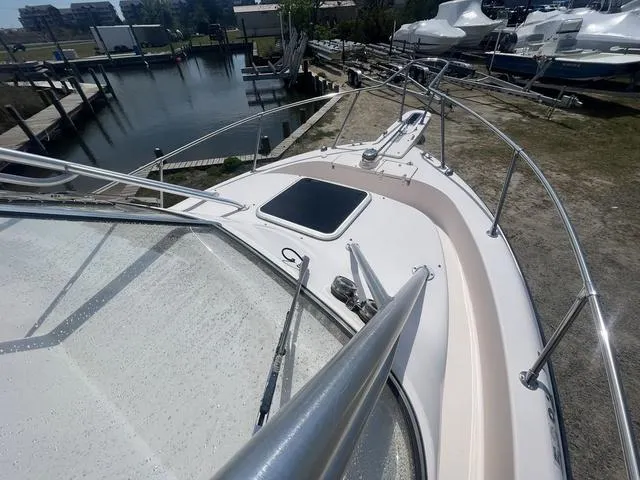 Slide: The Image of 2007 Grady-White 282 Sailfish boat deck with railing, docked near water. - 8
