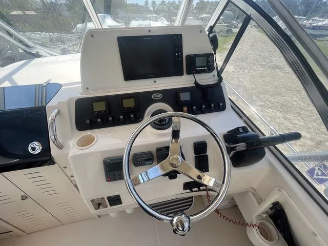 Slide: The Image of 2007 Grady-White 282 Sailfish boat dashboard with steering wheel and navigation equipment. - 10