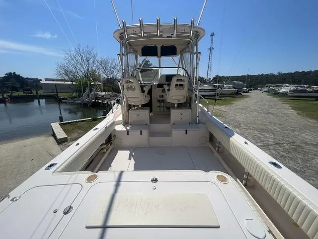Slide: The Image of 2007 Grady-White 282 Sailfish boat, spacious deck, dual seats, clear sky, marina background. - 16