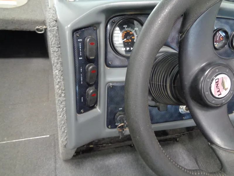 Slide: The Image of Dashboard of a 2003 Lund 1800 Fisherman OB boat with steering wheel and gauges. - 10