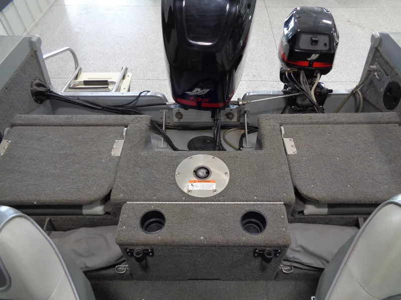 Slide: The Image of 2003 Lund 1800 Fisherman OB boat interior with motor and storage compartments. - 16