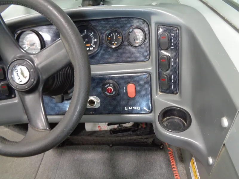 Slide: The Image of Dashboard of a 2003 Lund 1800 Fisherman OB boat with steering wheel and control panel. - 19