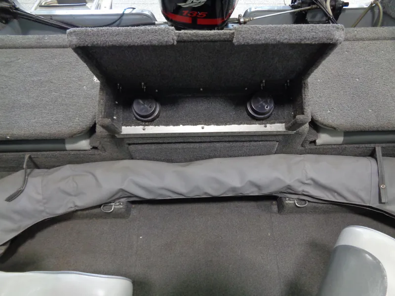 Slide: The Image of 2003 Lund 1800 Fisherman OB boat interior with storage compartment and seating area. - 21