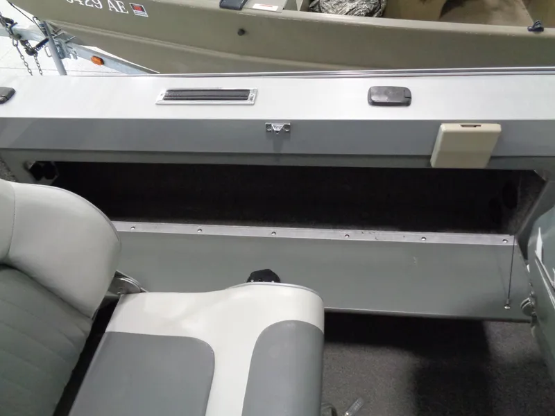 Slide: The Image of 2003 Lund 1800 Fisherman OB boat interior with seating and storage compartment. - 4