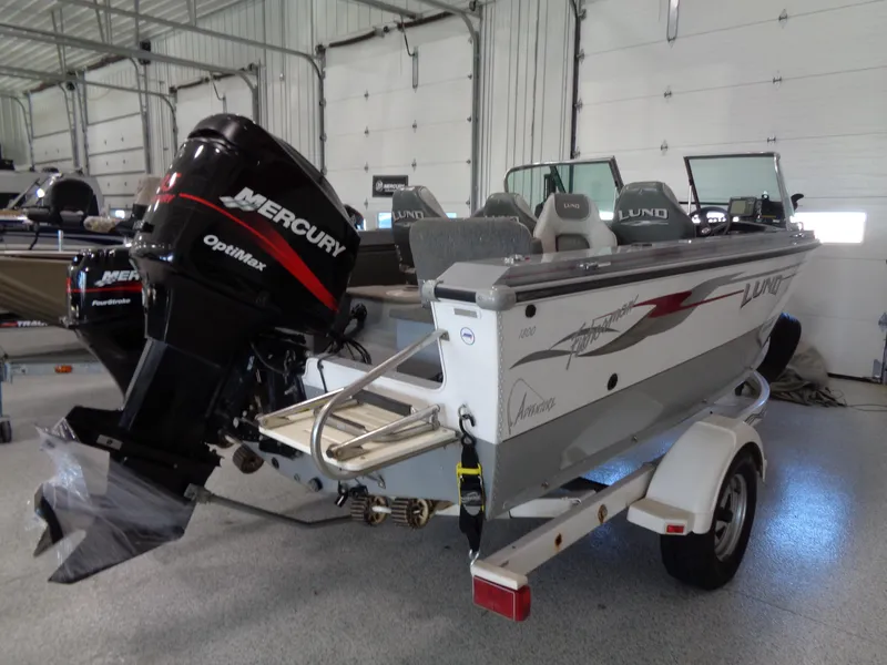 Slide: The Image of 2003 Lund 1800 Fisherman OB boat with Mercury Optimax engine in a garage. - 5