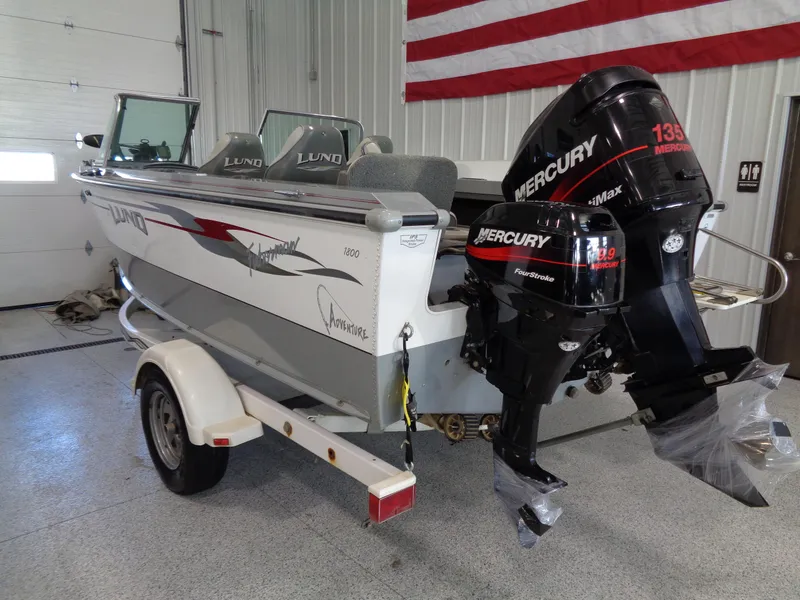 Slide: The Image of 2003 Lund 1800 Fisherman OB boat with Mercury outboard motor in a garage. - 6