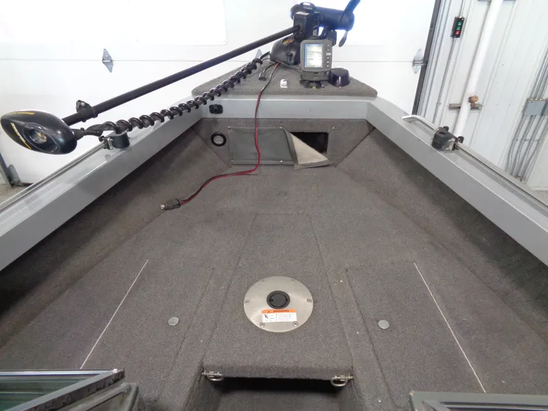 Slide: The Image of 2003 Lund 1800 Fisherman OB boat interior with fishing equipment and storage compartments. - 9