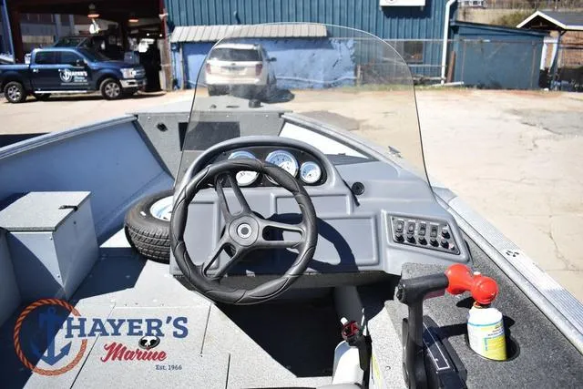Slide: The Image of Interior view of 2015 Lund 1800 Alaskan boat with steering wheel and dashboard. - 10
