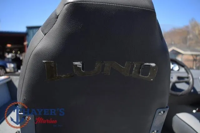 Slide: The Image of Lund 1800 Alaskan 2015 boat seat with logo, outdoor setting. - 12