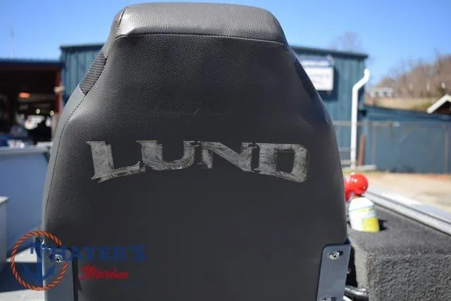 Slide: The Image of Lund 1800 Alaskan 2015 boat seat with logo, outdoor setting. - 13