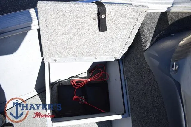 Slide: The Image of Open storage compartment in 2015 Lund 1800 Alaskan boat with battery and cables. - 16