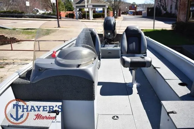 Slide: The Image of 2015 Lund 1800 Alaskan boat interior with seating and console, displayed at Thayer's Marine. - 17
