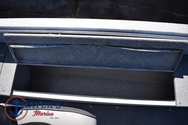 Slide: The Image of Open storage compartment in 2015 Lund 1800 Alaskan boat, featuring Thayer's Marine logo. - 19
