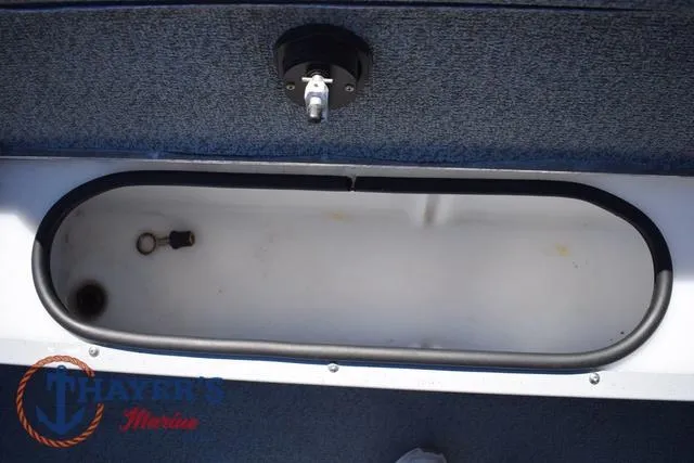 Slide: The Image of 2015 Lund 1800 Alaskan boat storage compartment with blue carpeted interior. - 21