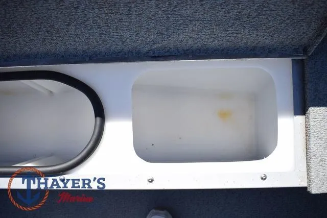 Slide: The Image of Storage compartment in a 2015 Lund 1800 Alaskan boat, featuring Thayer's Marine branding. - 22