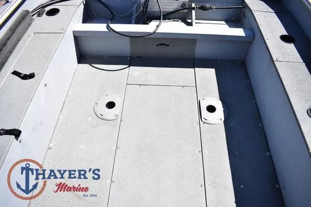Slide: The Image of 2015 Lund 1800 Alaskan boat interior with Thayer's Marine logo, featuring spacious deck layout. - 25