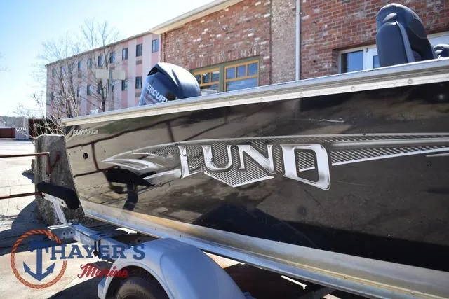 Slide: The Image of 2015 Lund 1800 Alaskan boat on trailer, parked near brick building. - 31